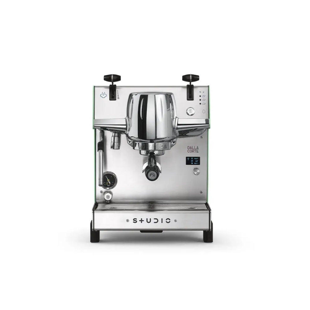 A professional espresso machine by dalla corte, featuring a polished stainless steel body, a chrome-plated portafilter holder, and black accents including knobs and wheels, shown against a plain white background.